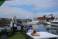Grahame Wear checking if the sausages are ready